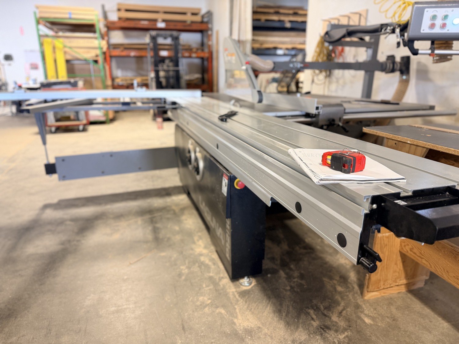 Sliding table saw with tape measure and cut notes