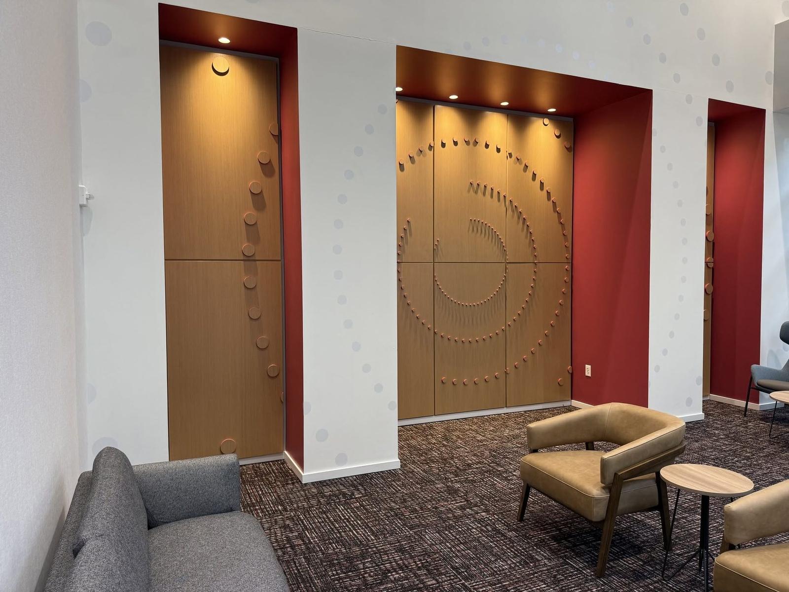 Sculptural hardwood wall with a spiral of dimensional discs